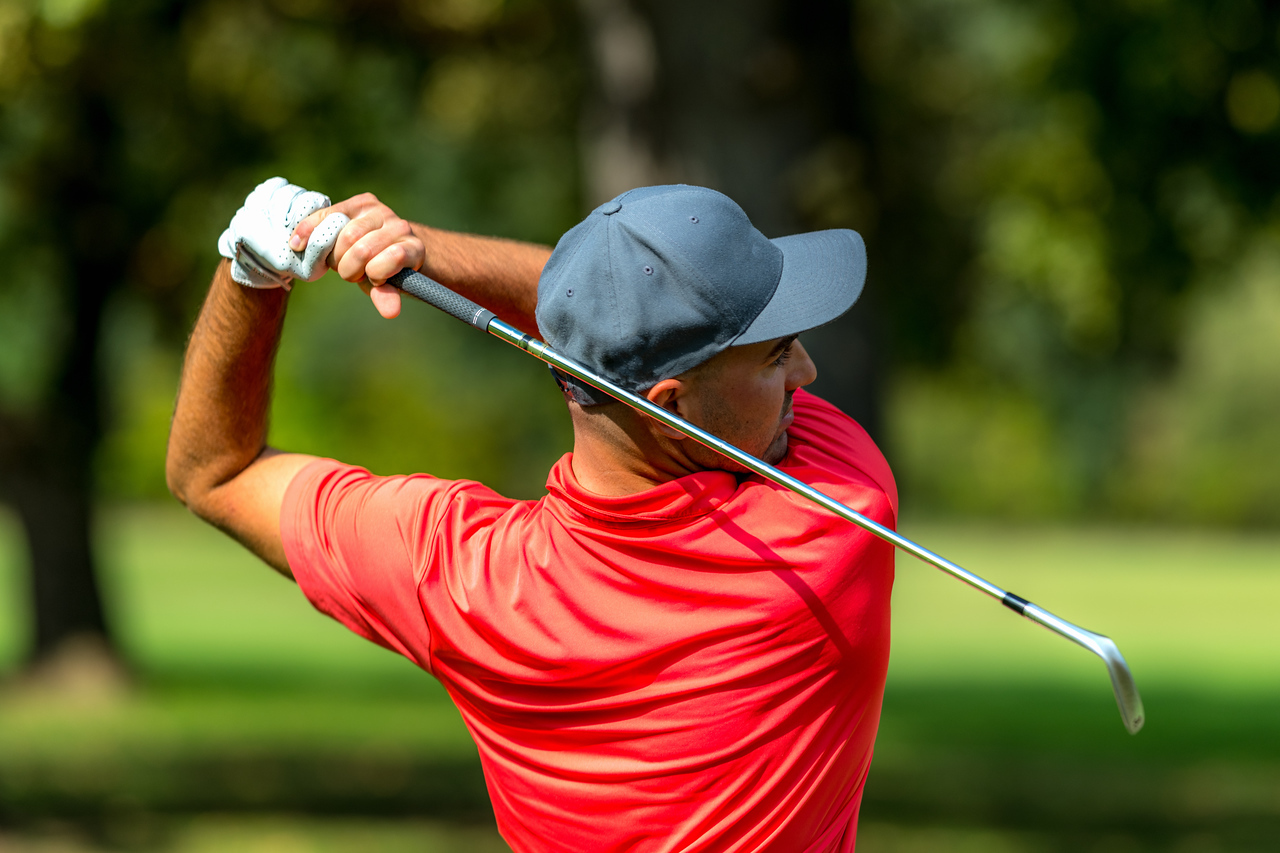 Rear view of a man playing golf