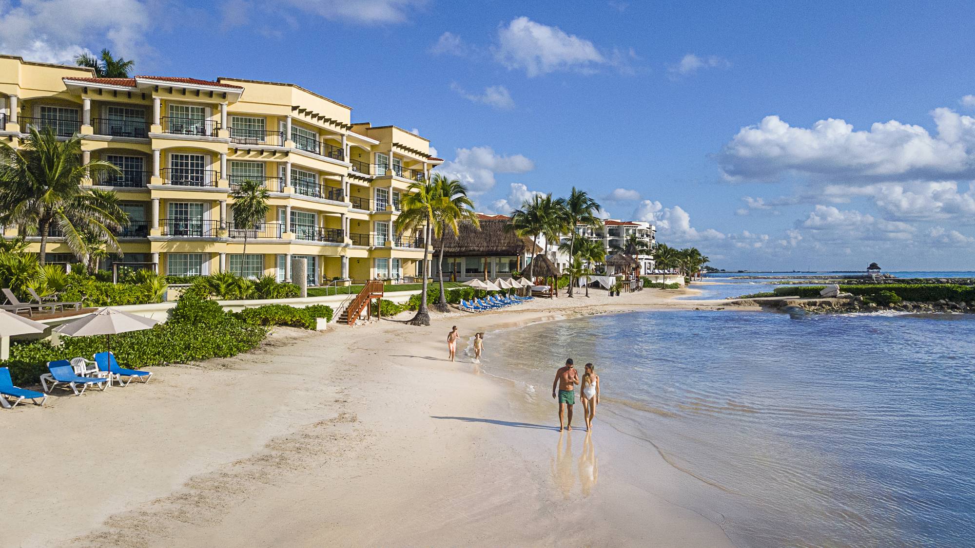 Family eating by the beach at an all-inclusive resort