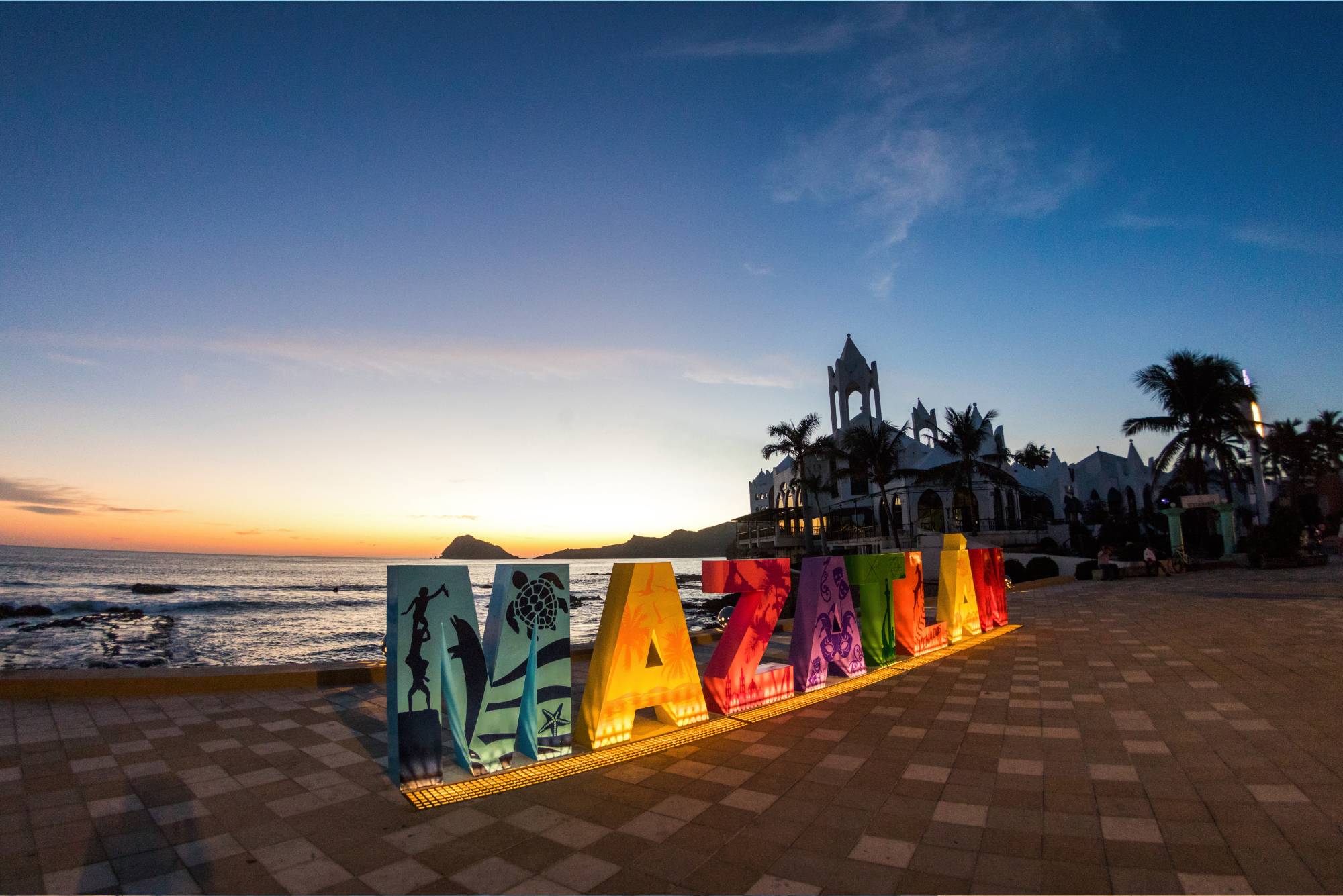 Colorful Mazatlán letters in front of the Malecón, with the Pacific Ocean in the background