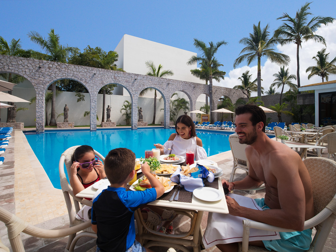 Family Dining by the Pool at an Affordable All-Inclusive Resort
